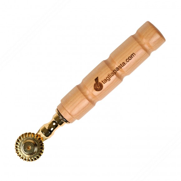 Golden brass pasta cutter with single toothed blade. Maple wood handle