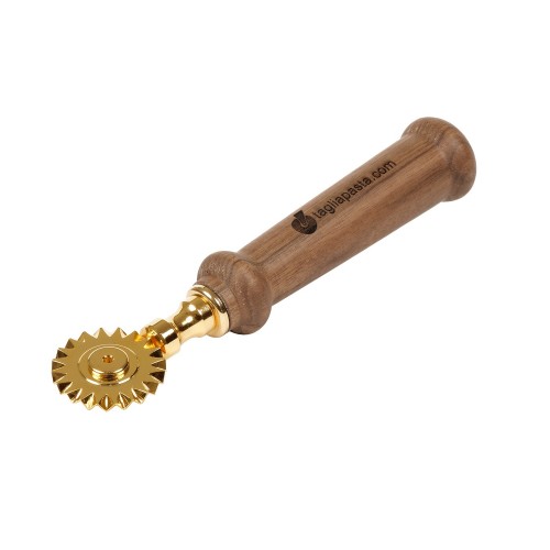 Golden brass pasta cutter with single toothed blade. Walnut wood handle